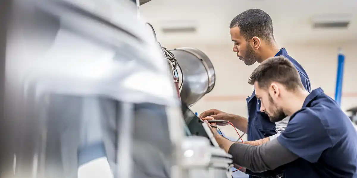 Two Engineering students working on large product