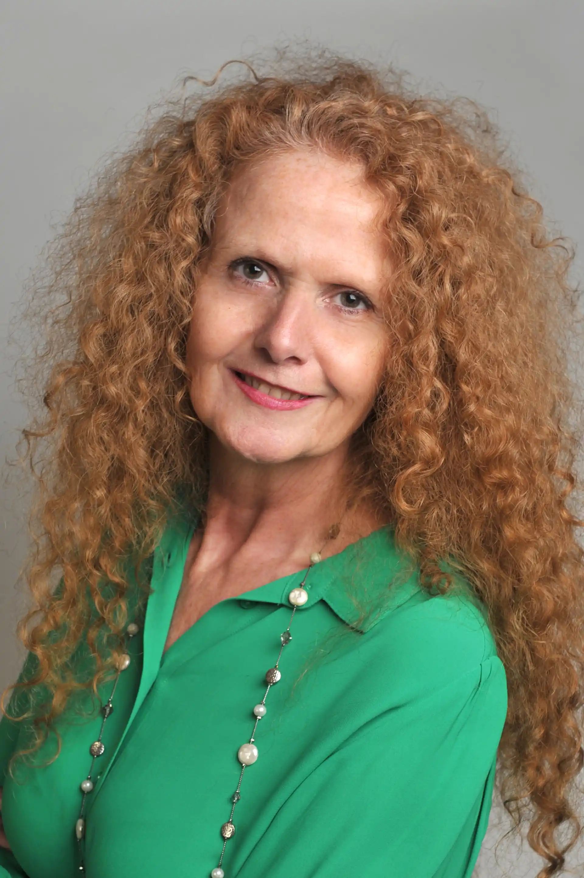 Alison Parkes smiling at camera in a green shirt