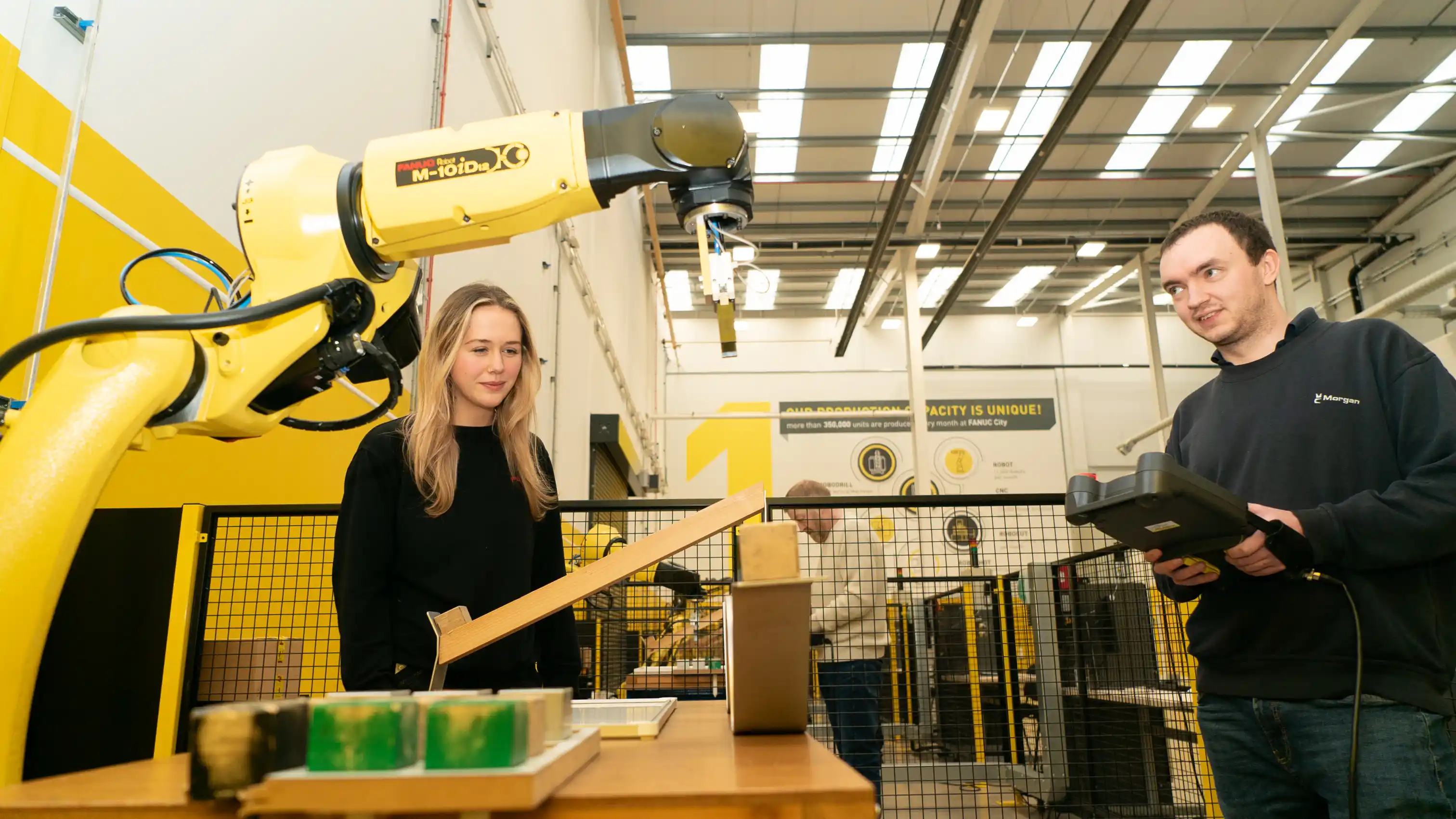 Teacher demonstrating to a manufacturing student