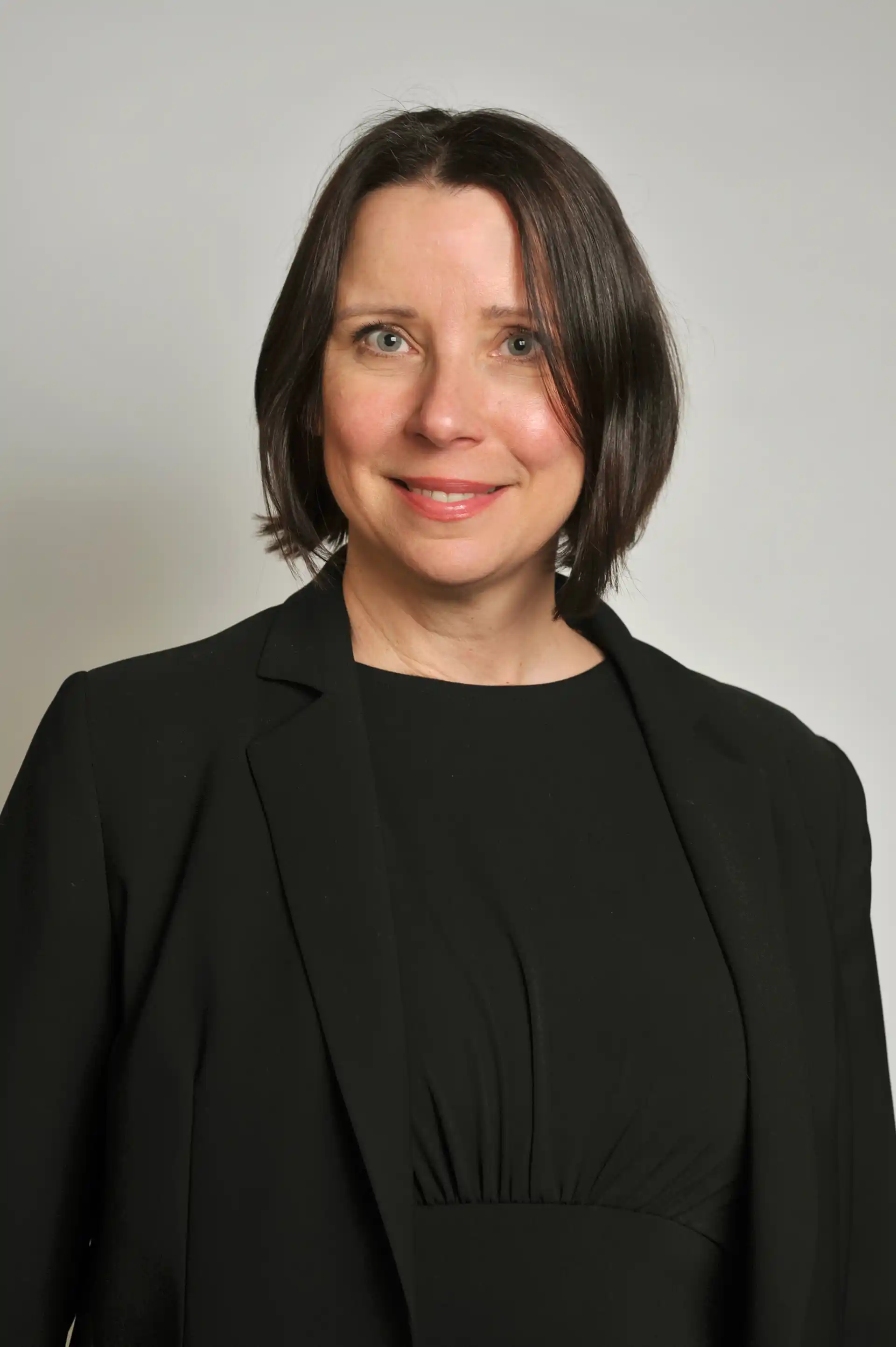 Anna Fritz in black outfit smiling at camera.