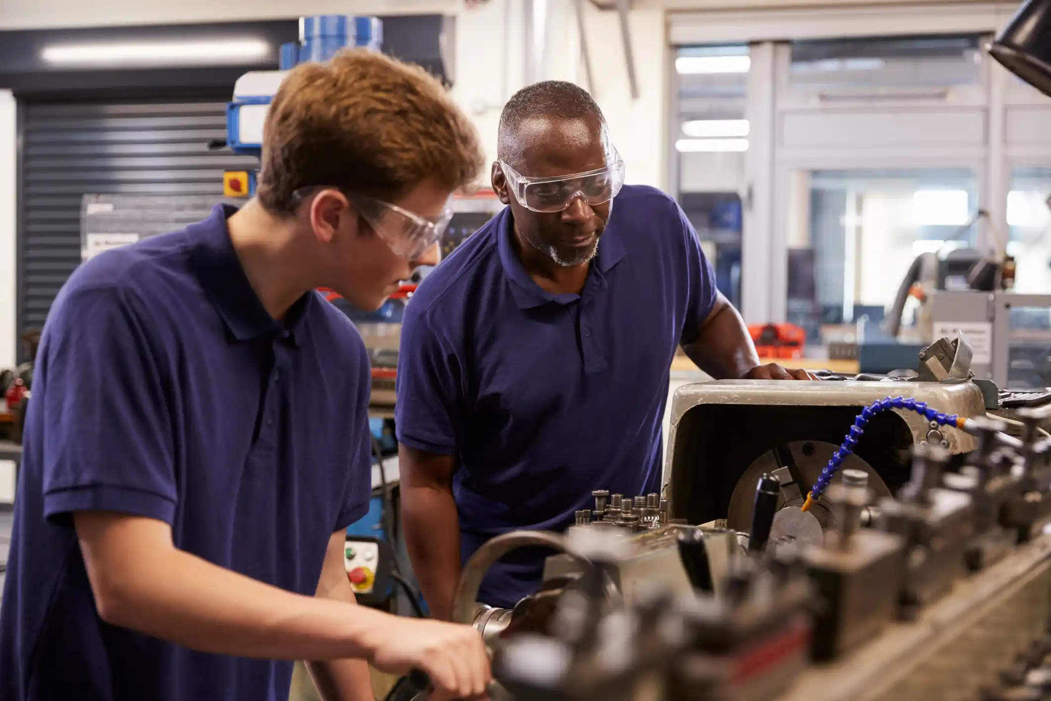 Two people looking at equipment in a workplace