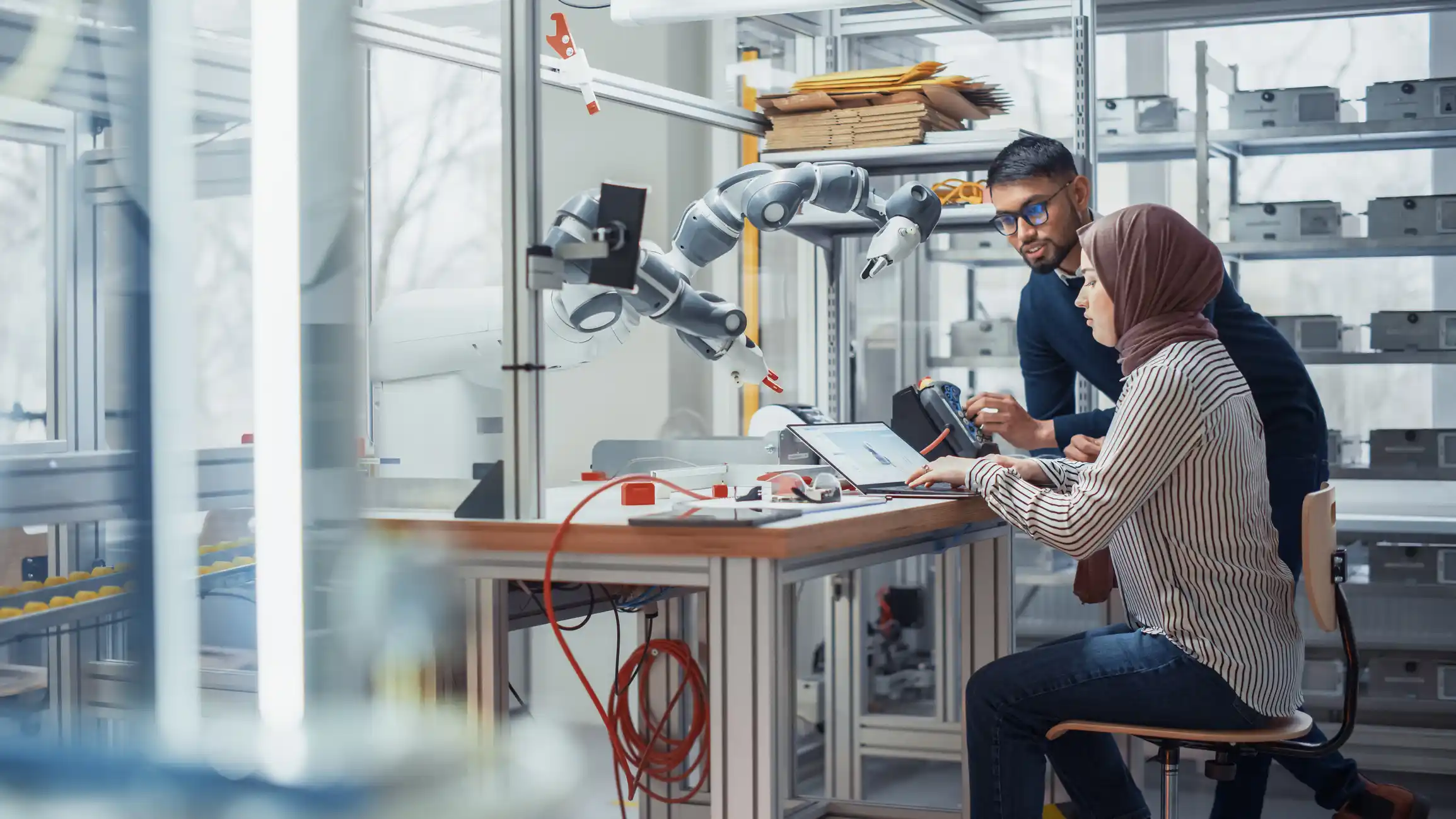 Two people working with computer equipment