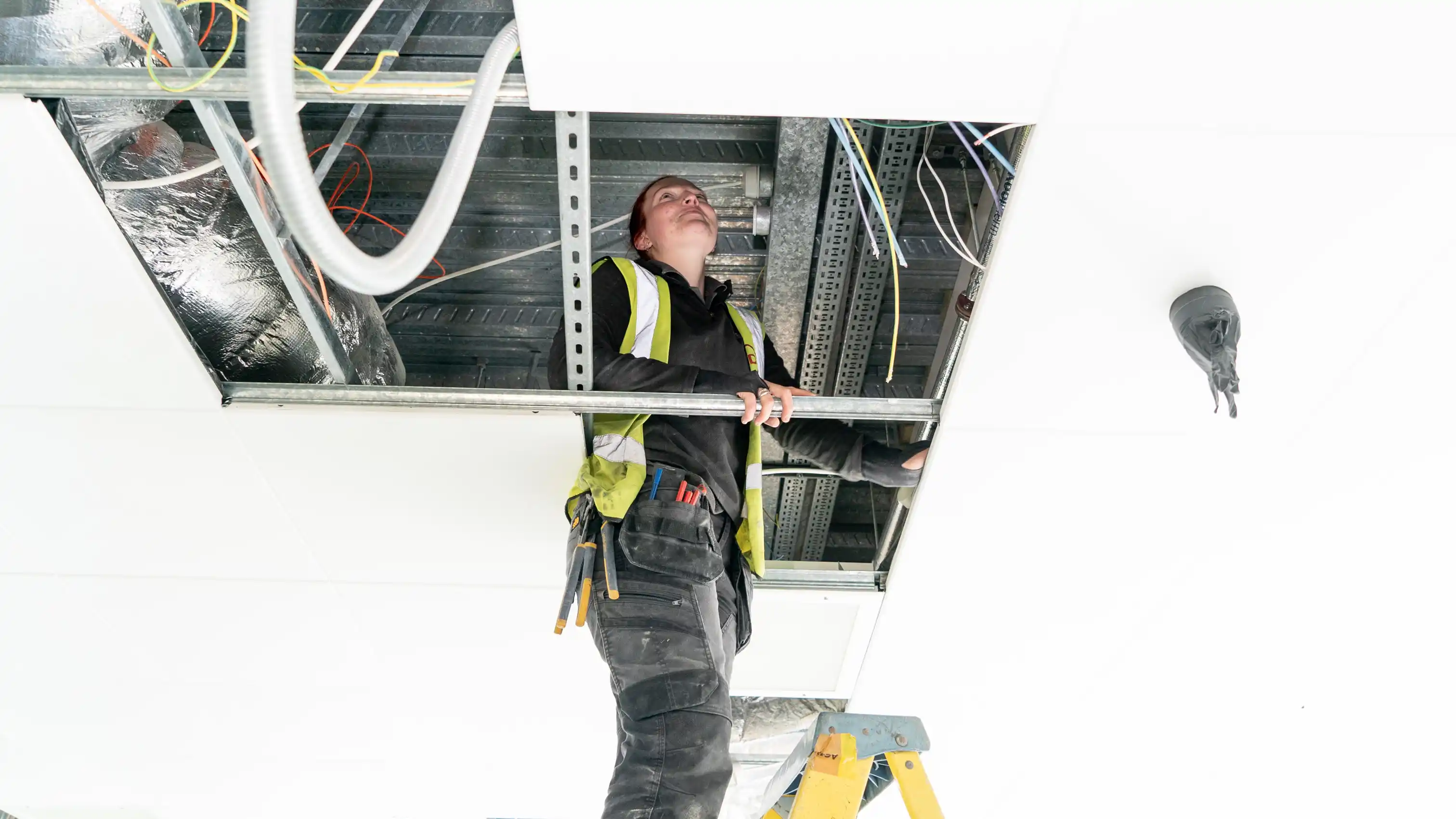 Specialist inspecting roofing panels 