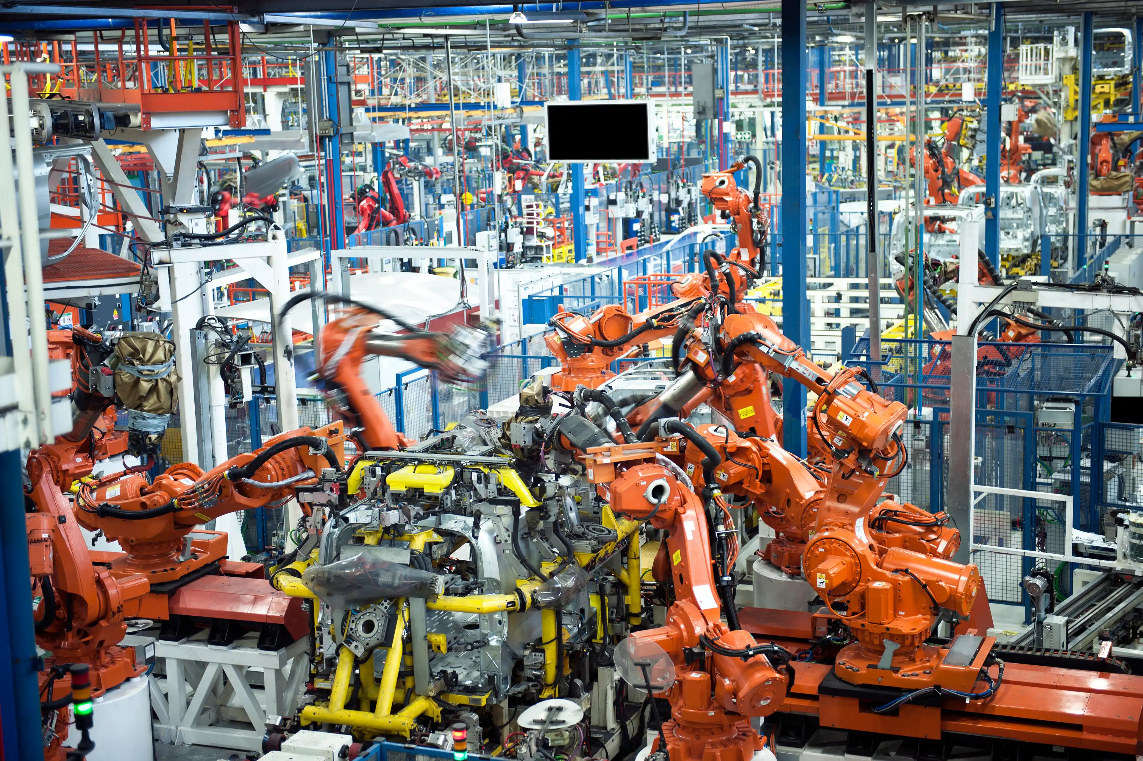 Large red robot machinery in an engineering lab.