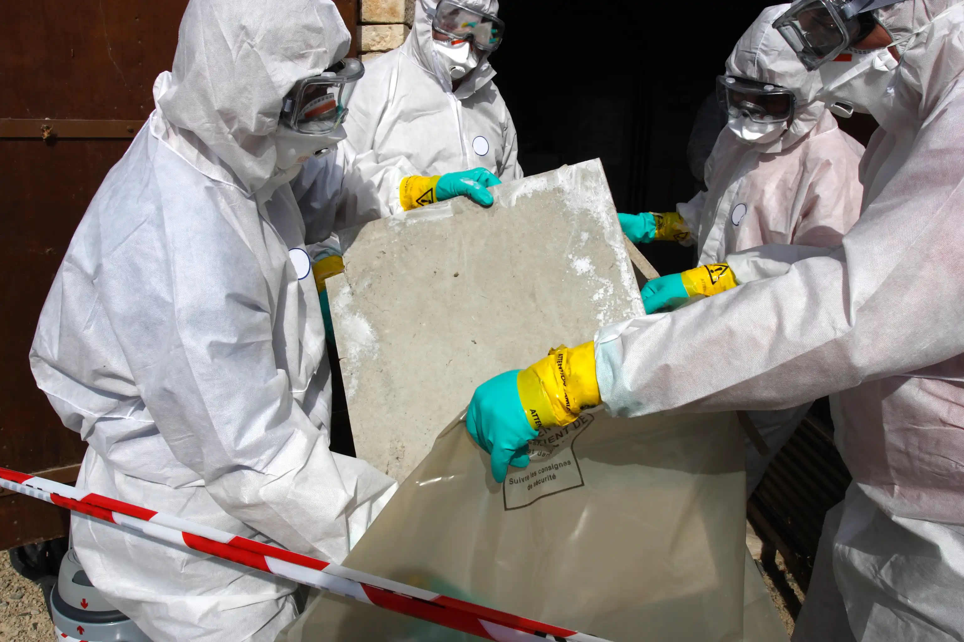 Engineering teacher working with students in hazmat suits