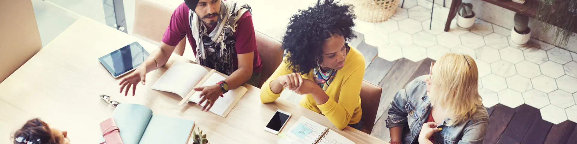 A group of coworkers discussing solutions around a conference table.