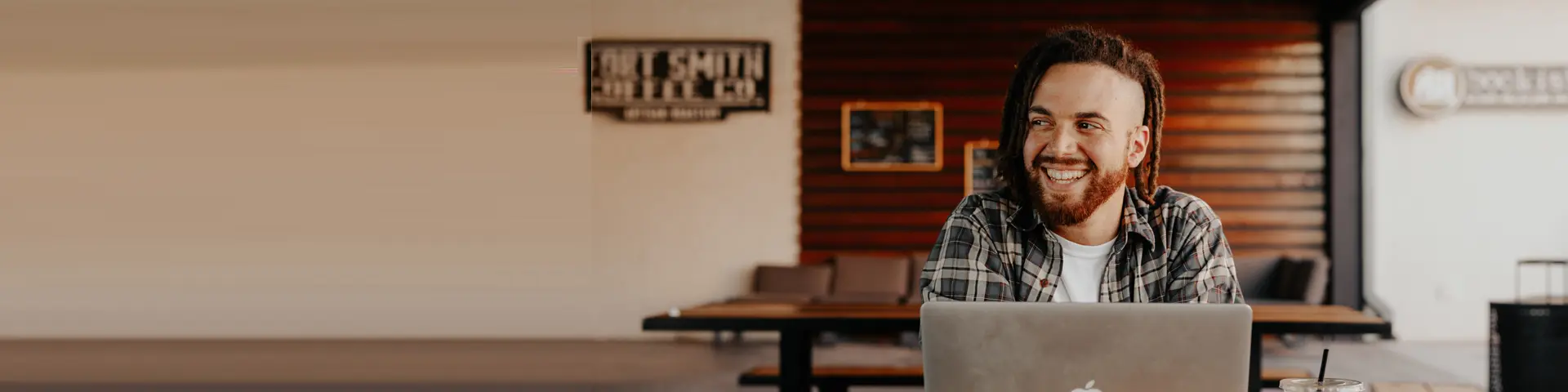 Image of man smiling at laptop