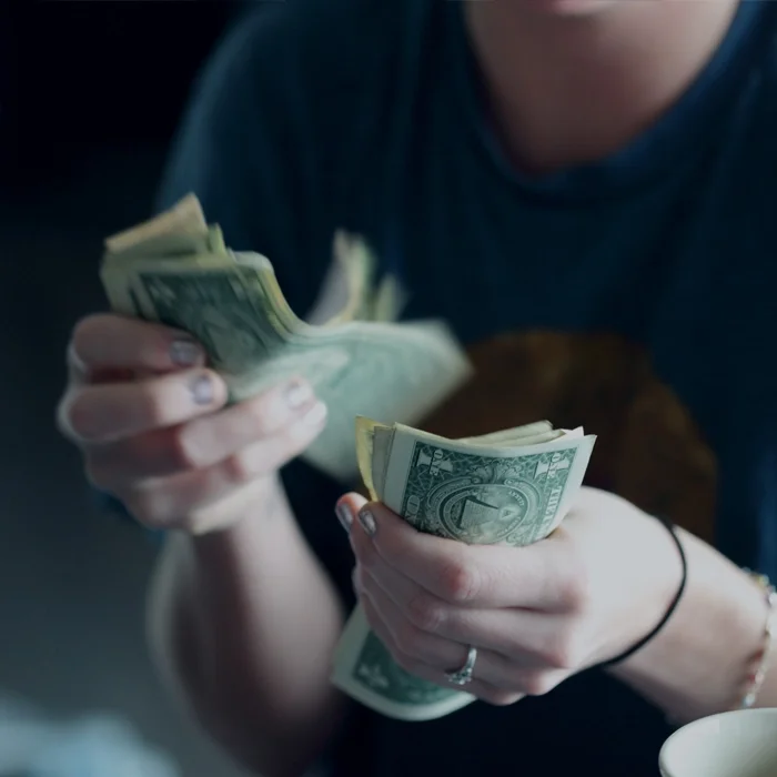 Image of woman holding money