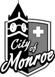 Logo for City of Monroe - a shield with a clock tower and text "city of monroe" across it