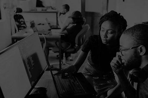 Man and woman inspecting financial data together.