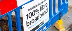 Blue construction barrier with G.Network board which says 'Installation in progress 100% fibre broadband'
