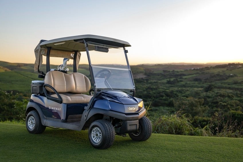 A Club Car Tempo in front of a golf course