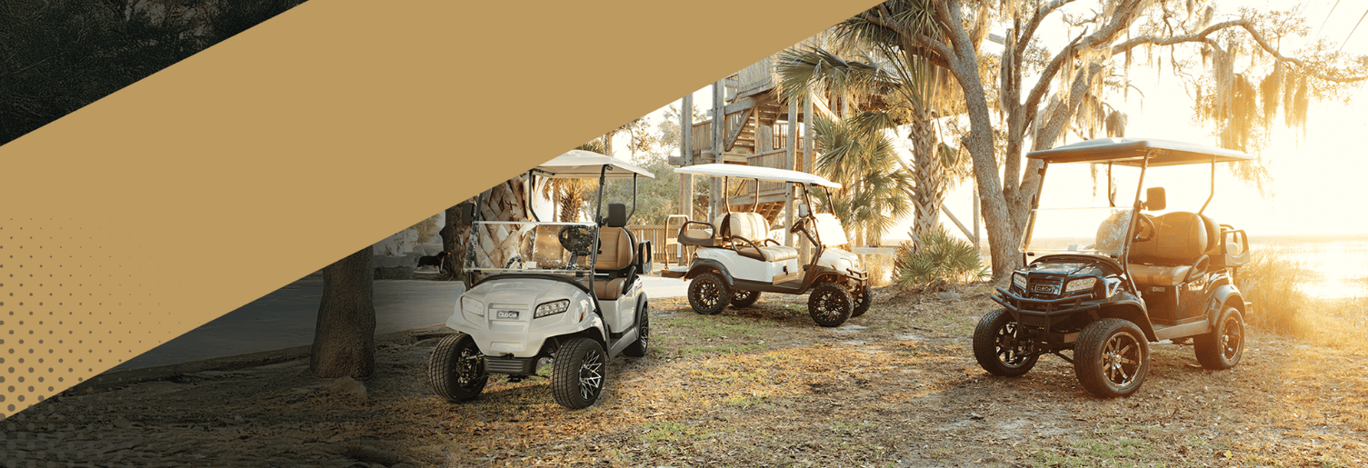 Three Club Car golf carts parked outside.