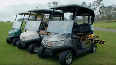 Three Tempo Club Car golf carts are parked on a golf course.