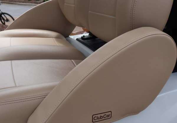 Padded armrests on a golf cart with the Club Car logo on it.
