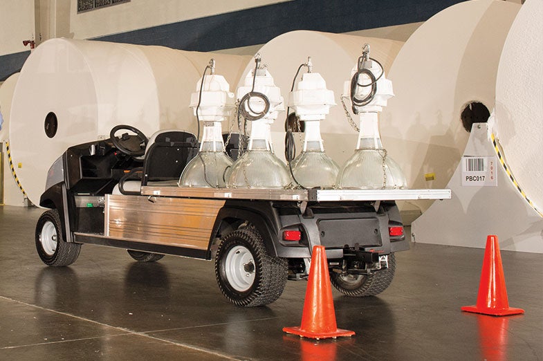 A Club Car Carryall 700 hauls heavy equipment.