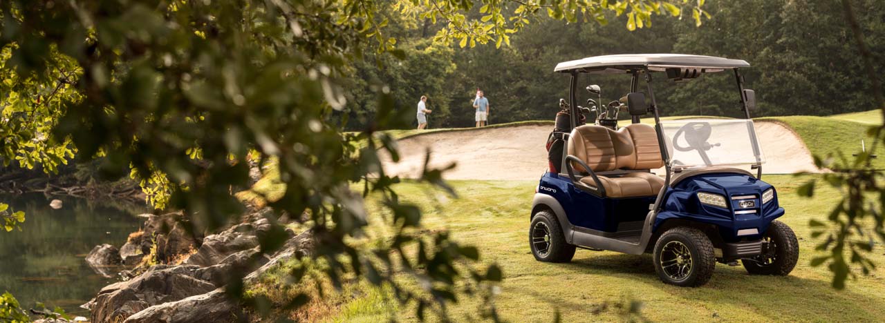 A Club Car Onward is packed on a golf course