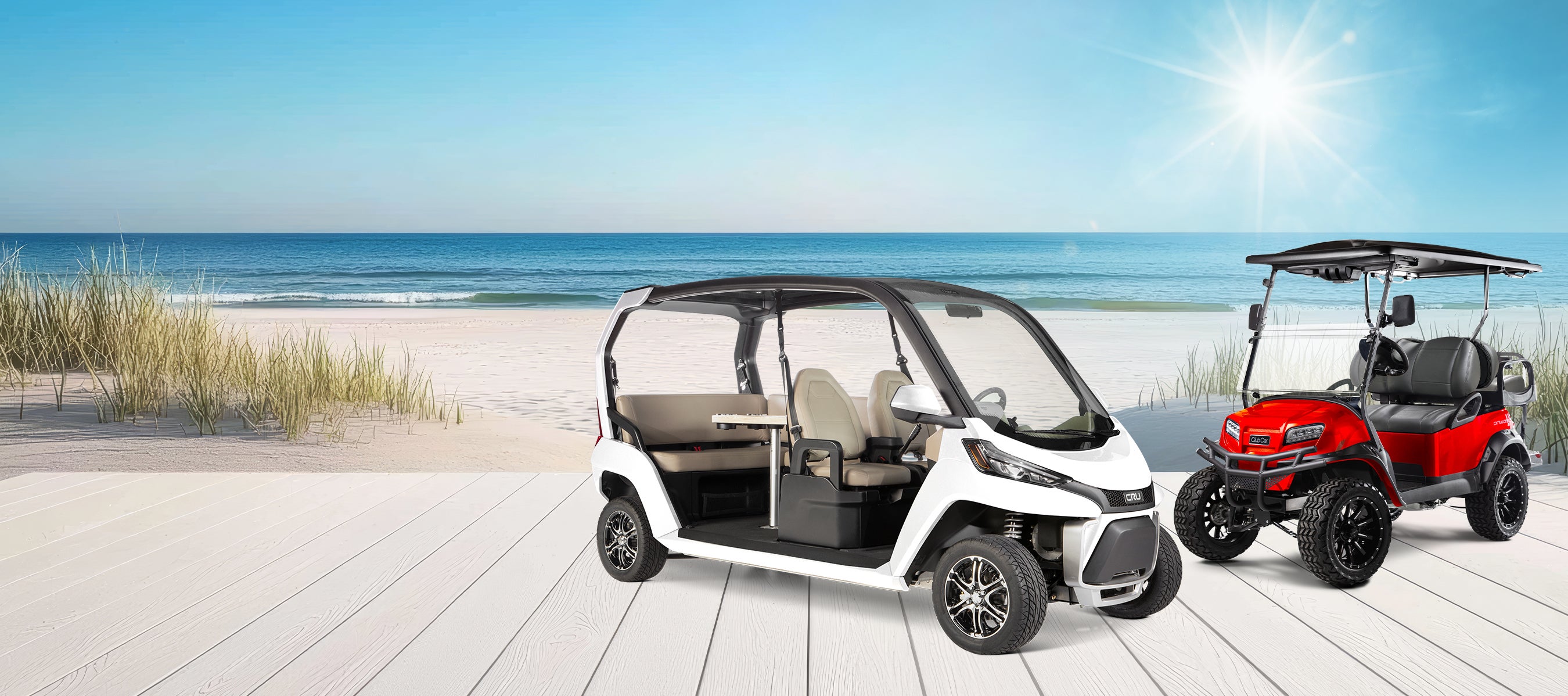A Club Car CRU and Onward vehicle sit side by side on a dock near the beach.