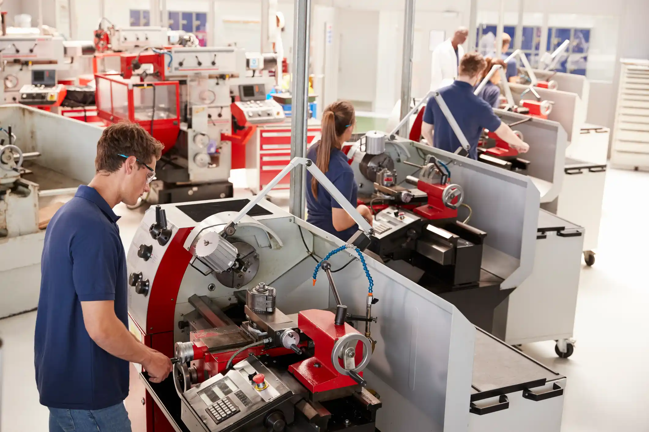 Students using machines in workshop