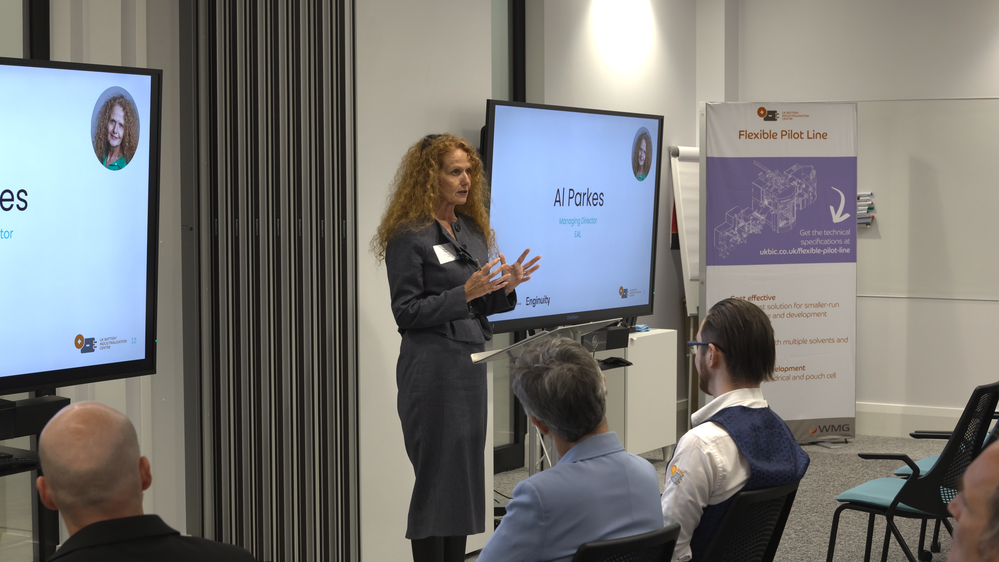 A woman is speaking to an audience