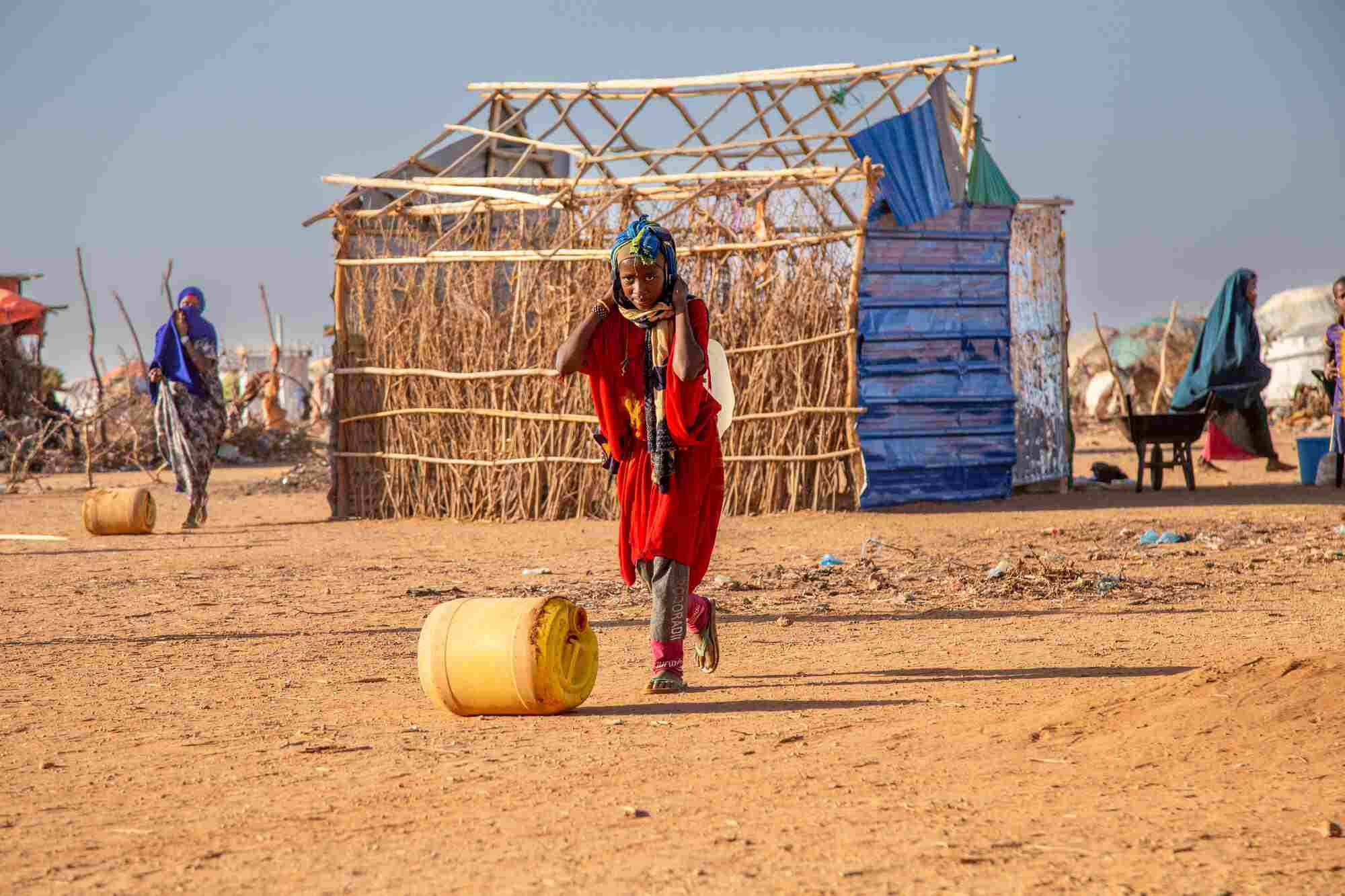 In Somalia, a child rolls a canister of water through the Internally Displaced Person’s camp. 