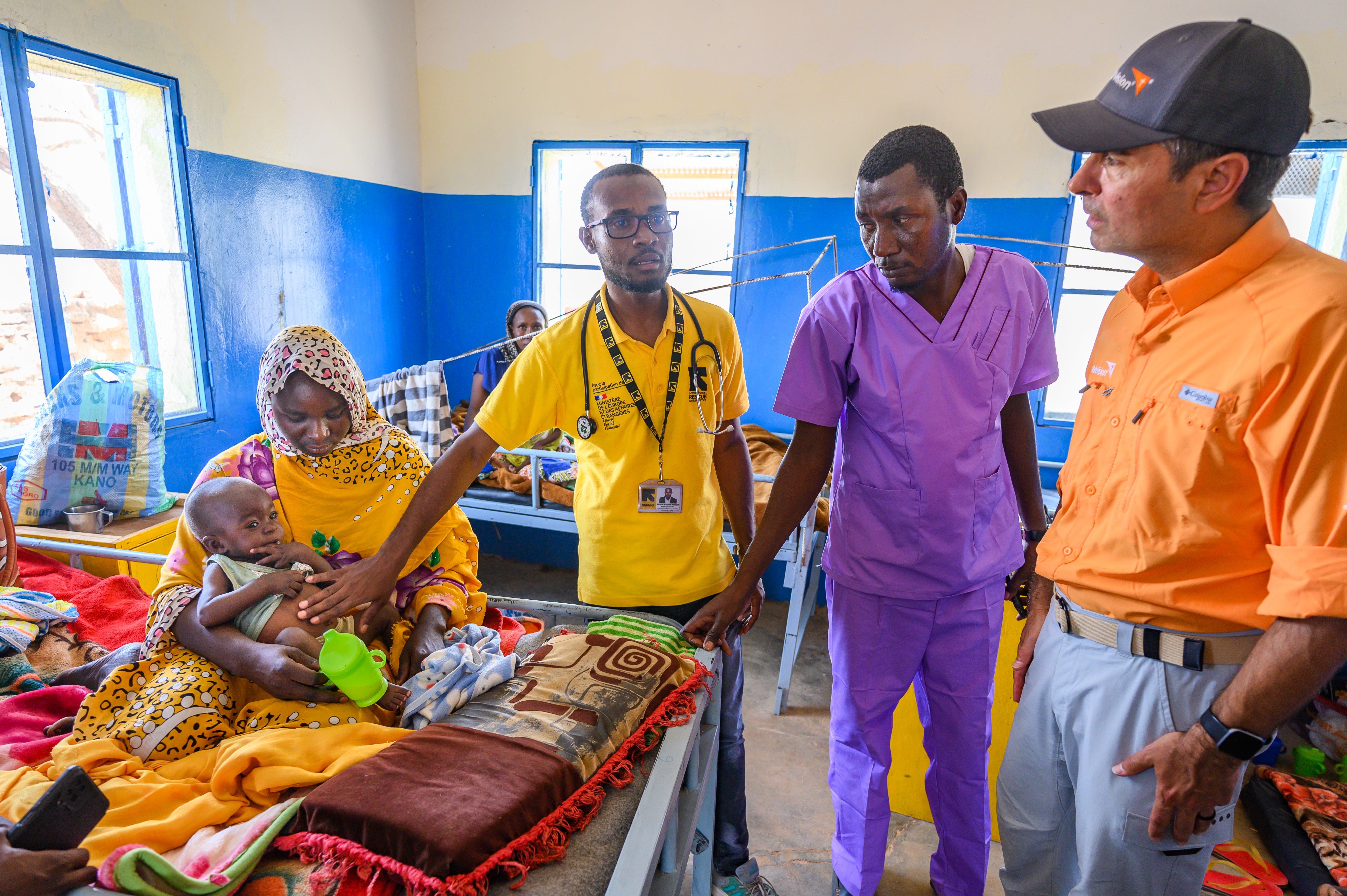 A humanitarian team visits a nutrition and health centre in Chad. The lead doctor is introducing the team to patients, predominantly children suffering from malnutrition