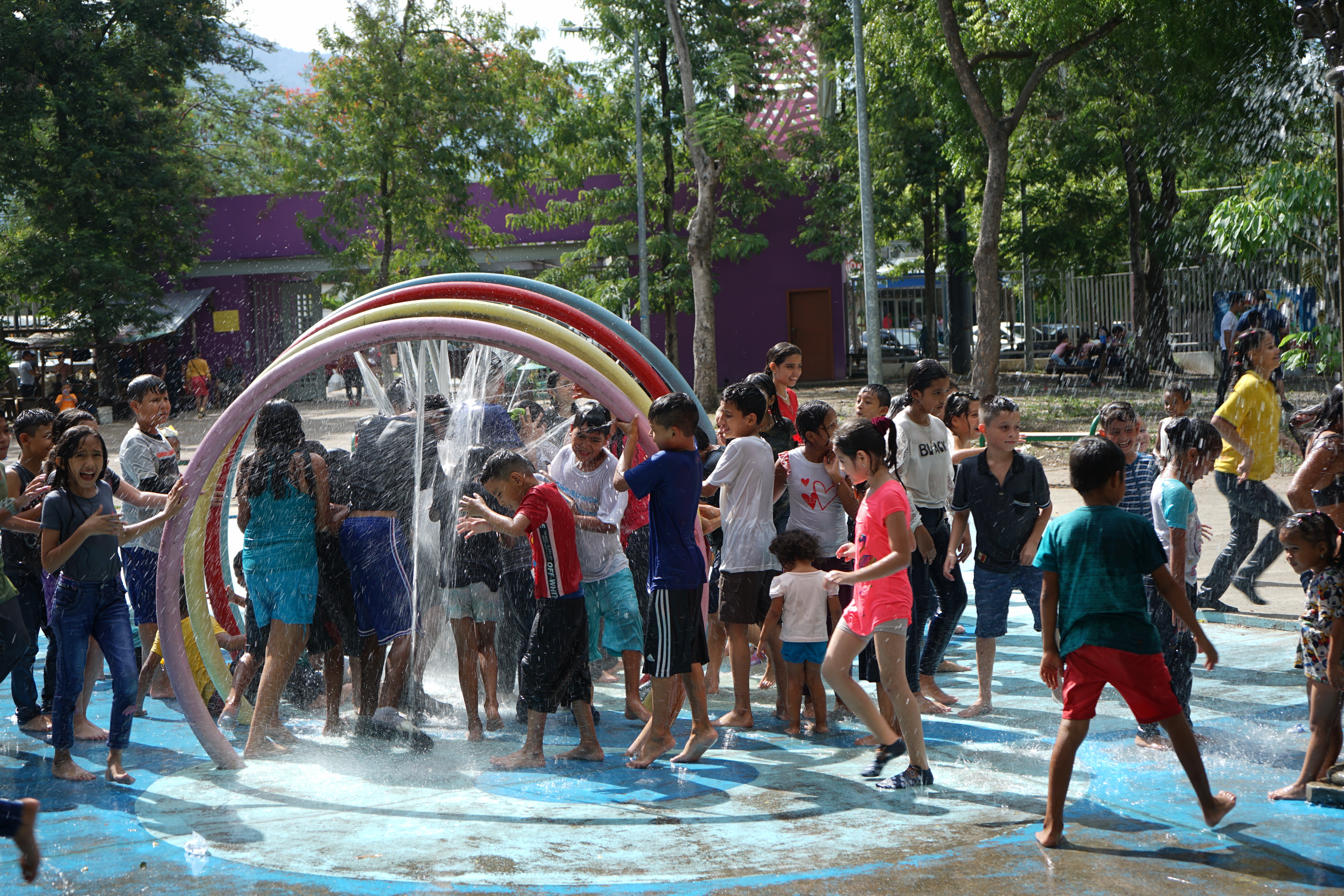 In Honduras, children play in a splash pad. 