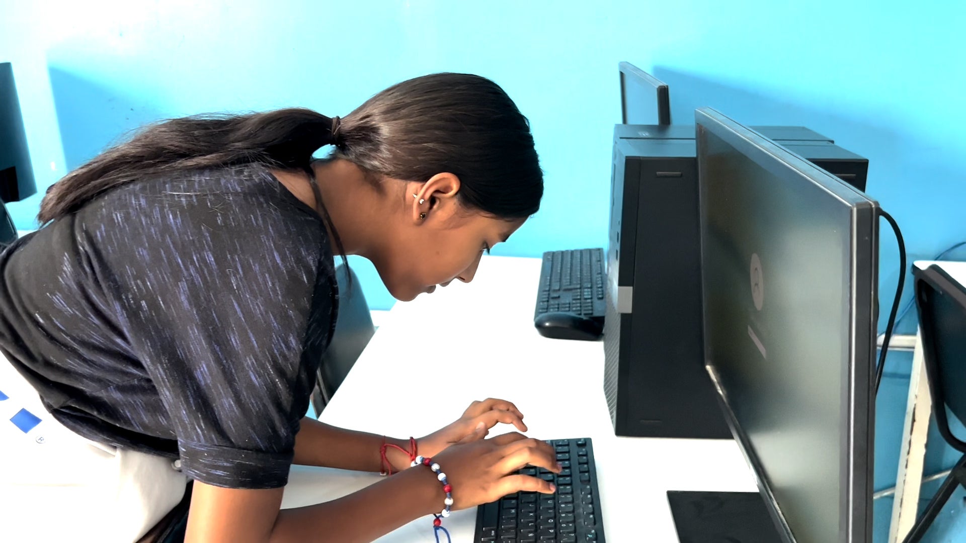 In Honduras, a young girl, Samantha, works at her computer. 