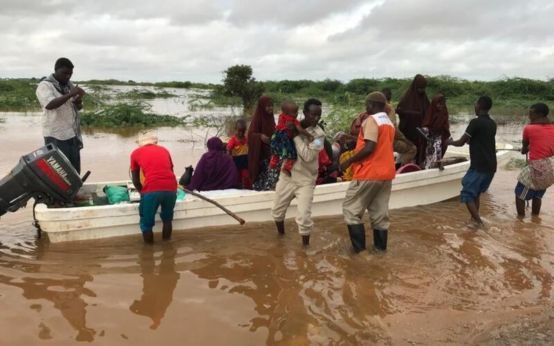 In Somalia, World Vision staff help families who have been evacuated due to flooding off the boat.