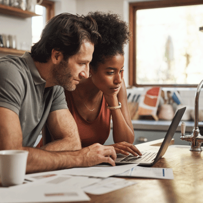 Two people looking at a laptop