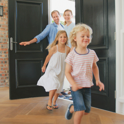 Kids entering the door of their new home