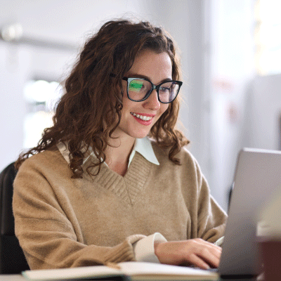Lady with glasses working on laptop