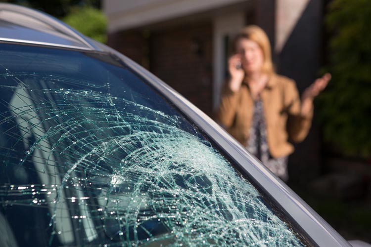 Woman Phoning For Help After Car Windshield Has Broken. Who's responsible if a neighbor cracks my windshield in Tennessee?