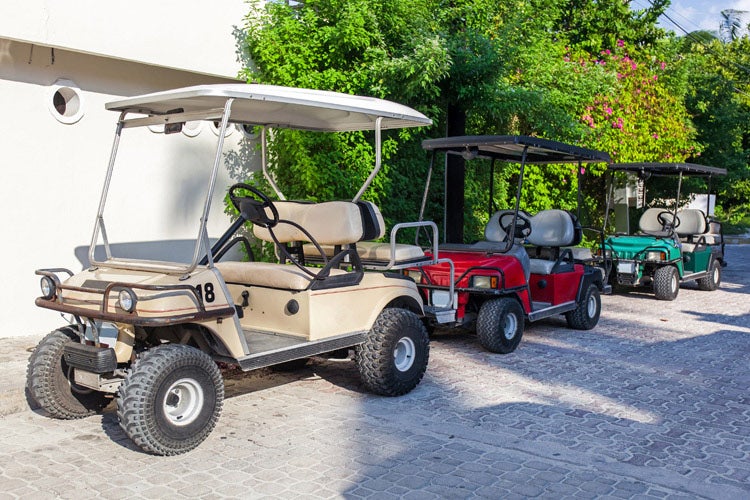 These golf carts are parked. Maybe the owner is wondering, how much is golf cart insurance in NJ? 