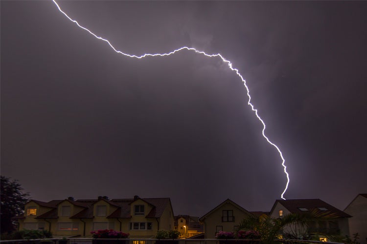 Lightning in the night hitting a house on the ground. Tennessee lightning myths.