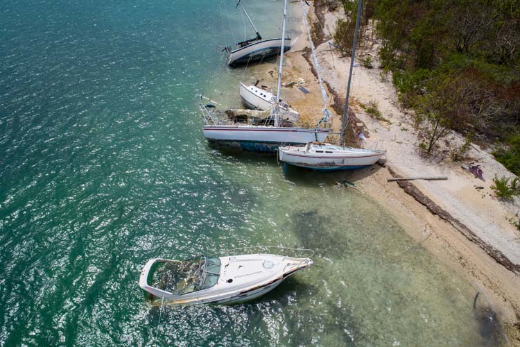 Sailboats washed ashore by hurricane. How to insure your boat against hurricane damage.