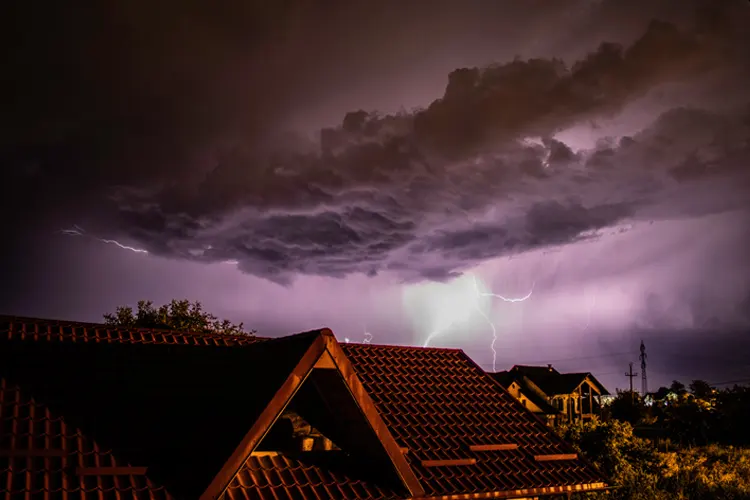 Lightning storm over a residential area. If a Storm Causes an Electrical Fire, What Kind of Insurance Will Cover the Damage?