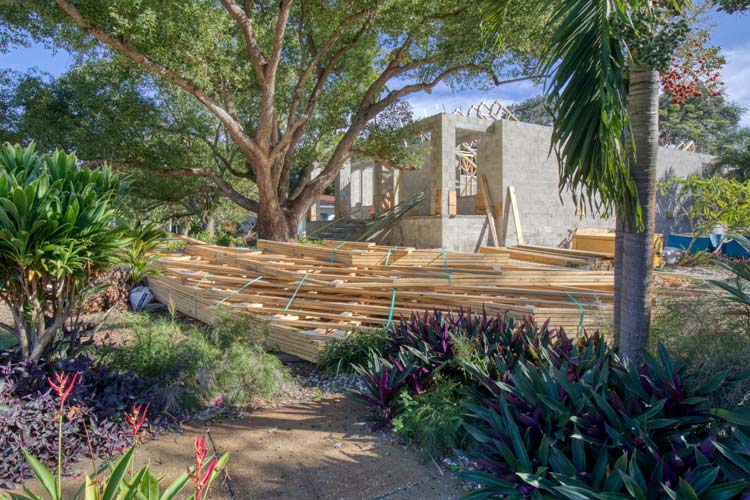 Trusses and lumber stacked up during home construction in St. Petersburg, FL. The #1 Trick to Rebuilding After a Florida Wildfire.