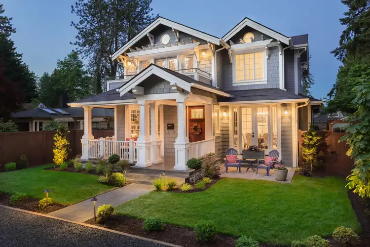 Beautiful luxury home exterior at twilight. Ways to reduce homeowners insurance.