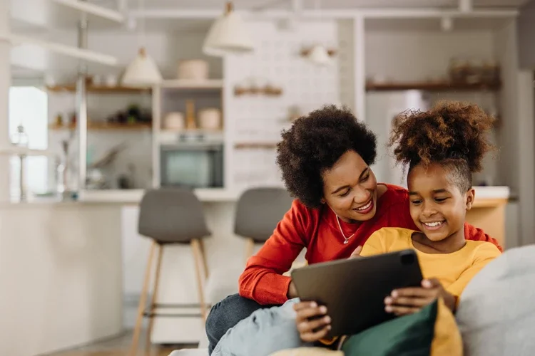 Mother and daughter enjoying time together with tablet. Top 5 Overlooked Personal Insurance Coverages. 