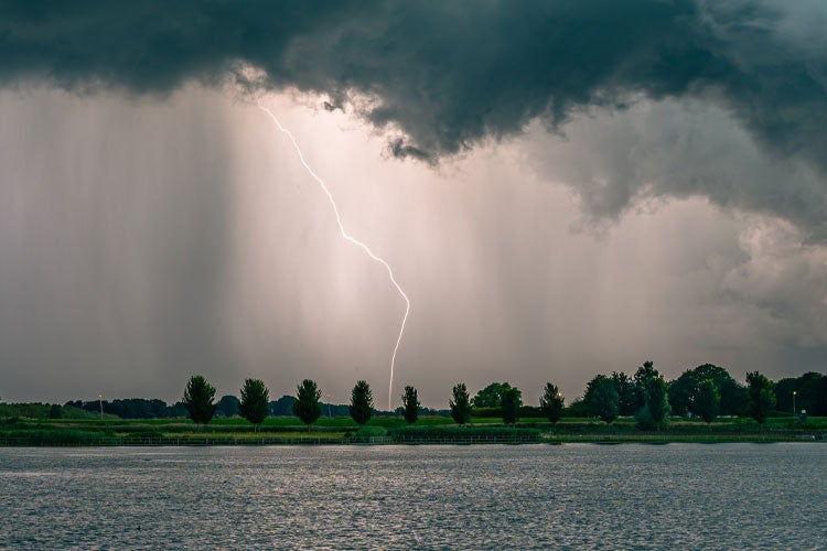 Positive cloud to ground lightning discharge near a lake at dusk. Which insurance covers lightning in Mississippi?