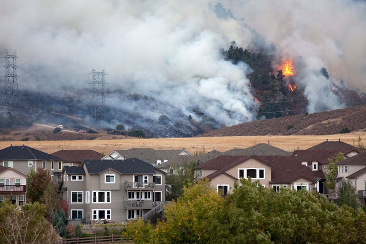 Wildfire burns behind homes. Without This Kentucky Wildfire Insurance Coverage, You Could Be In Big Trouble.