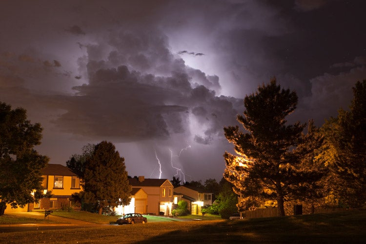 Thunderhead lightning strikes over Tennessee homes. Does home insurance in Tennessee cover lightning?
