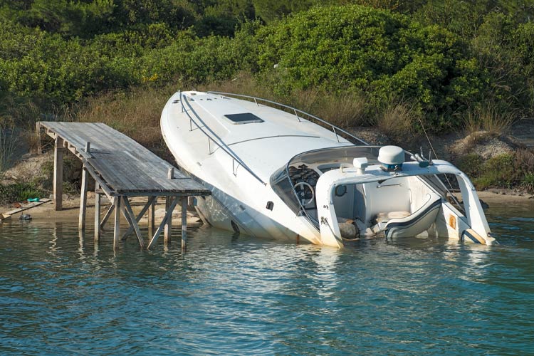 Speedboat beached and almost sunk at it's mooring. Renters Broke the Boat at My Vacation Home: Who's Responsible?