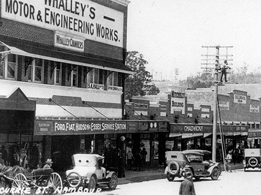 Whalley's Motor and Engineering Works and adjacent business premises, looking south along Currie Street, Nambour, 1930.
