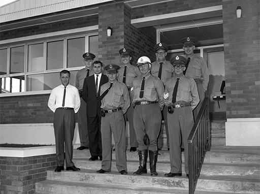 Police officers on the steps of the Nambour Police Station, Currie Street, Nambour, November, 1964. At the time of the official opening the station was to be upgraded with the posting of an additional traffic officer, increasing the station strength to more than 10 with a senior sergeant in charge.