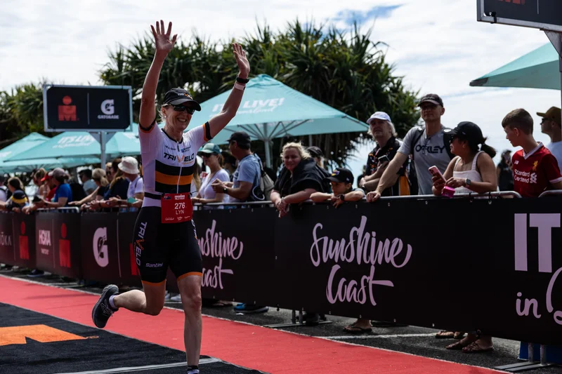IRONMAN Sunshine Coast - competitor running the red carpet chute to finish line