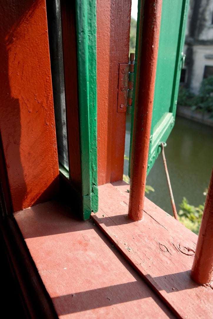 A first floor window, showing the steel rail on which the window slides