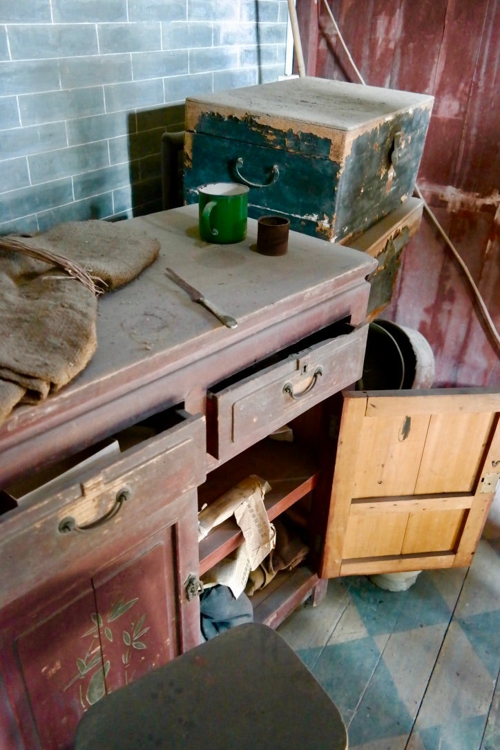 A cabinet in the first floor bedroom (note the painted chequer pattern on the floor)
