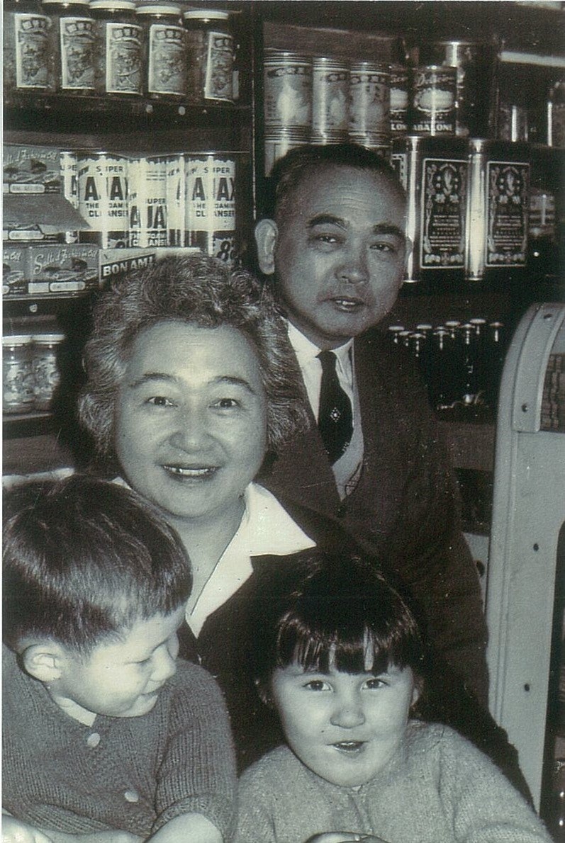 Wah Hook and Doris with two grandchildren at the family grocery store in Haymarket